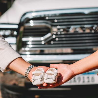 Hands Holding Tiny Baby Shoes