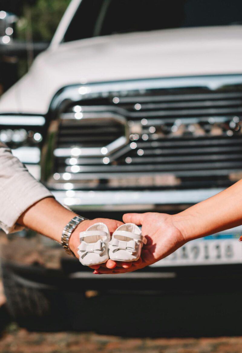 Hands Holding Tiny Baby Shoes