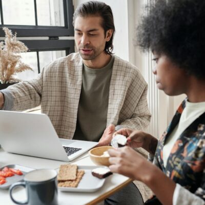 Man Using Laptop While Having Breakfast