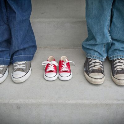 Person in Blue Denim Pants Wearing Gray and White Low Tops