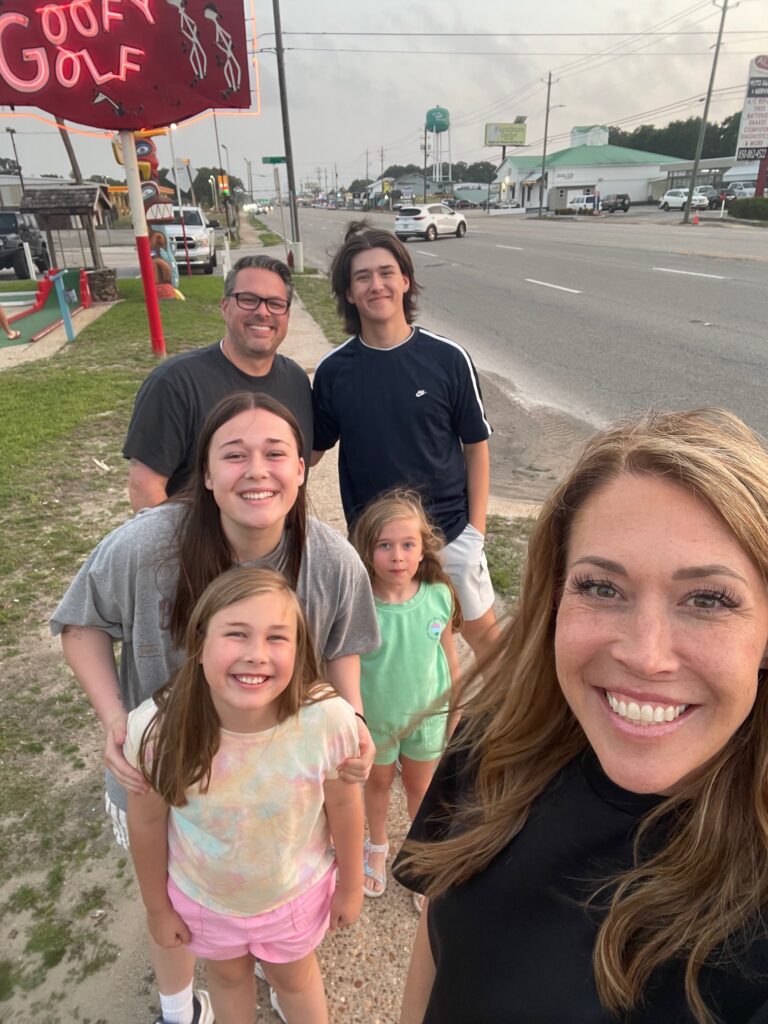 Family of six taking a selfie at Goofy Golf in Destin, Florida
