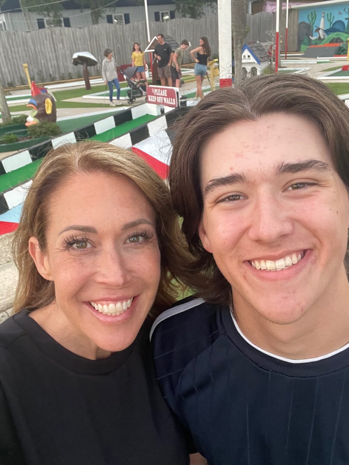 mom and son taking selfie at goofy golf in destin florida