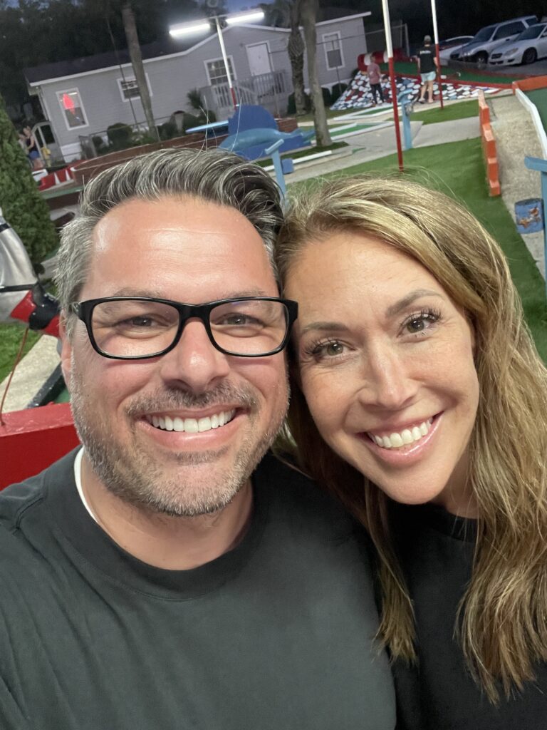 couple taking a selfi at Goofy Golf in Destin Florida