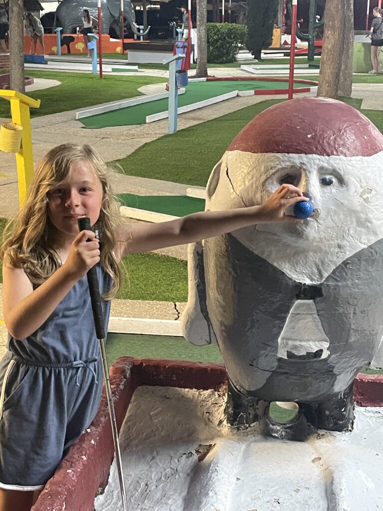 young girl posing with humpty dumpty at Goofy Golf in destin florida