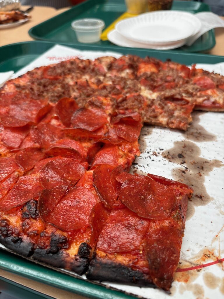 View of a half eaten pizza from marion's pizza in Dayton Ohio.
