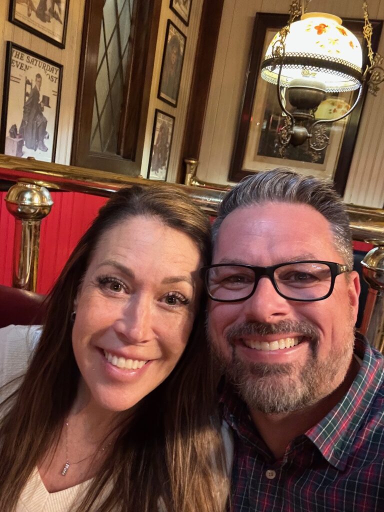 two people taking a selfie sitting in a booth at spaghetti warehouse