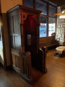 Confessional booth that is a decoration in the spaghetti warehouse restaurant
