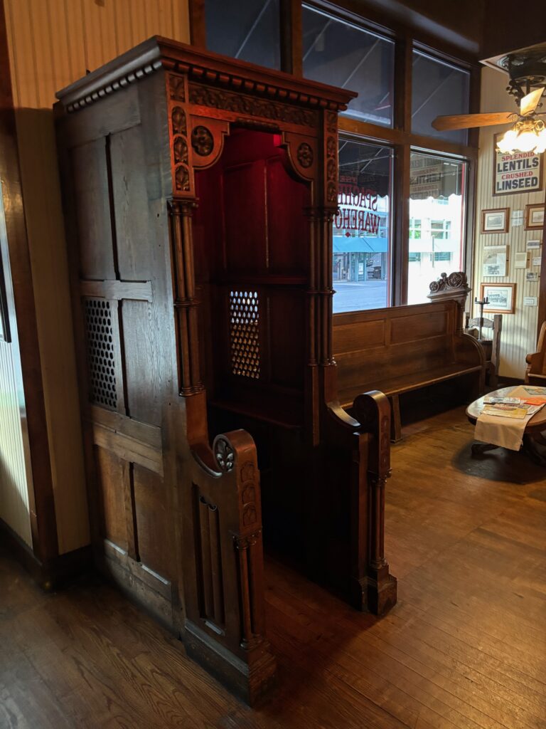 Confessional booth that is a decoration in the spaghetti warehouse restaurant