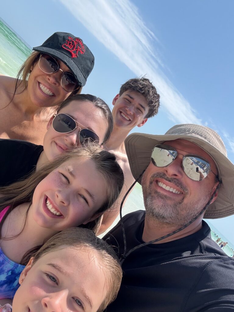 selfie of six family members at beach
