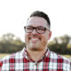 Picture of man wearing glasses in red and white plaid shirt